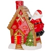 Kép 3/4 - Dekoráció MagicHome Karácsony, házikó Mikulással a tetőn, LED, terrakotta, 2xAAA, 27x13x34 cm